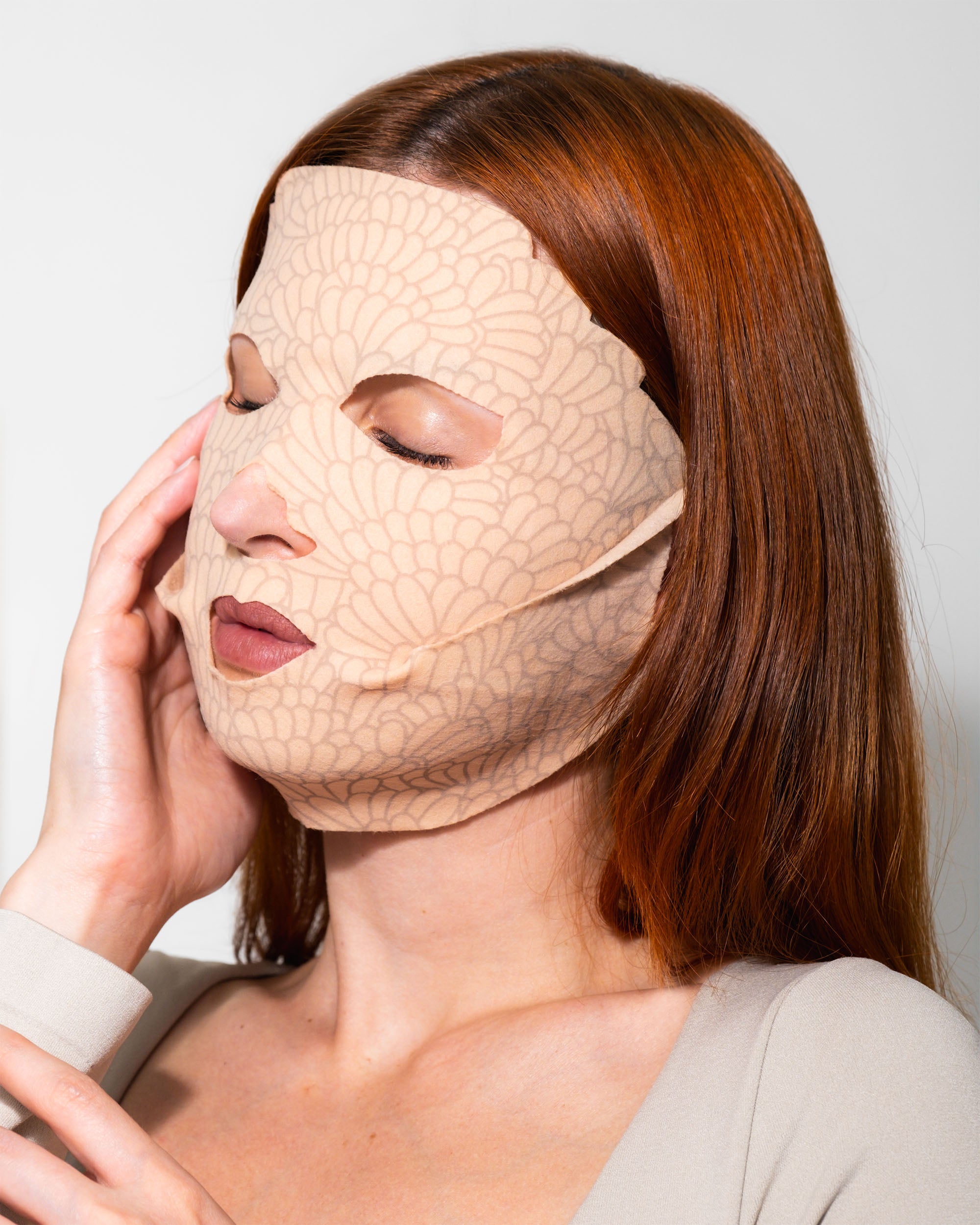 Applying Youth Revealed Face dry mask — 15-minute treatment for hydration, brightness, and firmer-looking skin